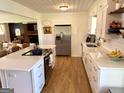Bright eat-in kitchen with stainless steel appliances, white cabinetry, and a spacious center island at 3095 Holbrook Sw Dr, Marietta, GA 30060