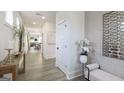 Inviting hallway featuring light wood floors, white trim, and a view into the open living spaces at 1818 Butterfly Way, Marietta, GA 30066