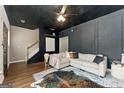 Inviting living room with modern paneling, neutral sectional sofa, and stylish decor at 1689 Camden Forrest Way, Riverdale, GA 30296