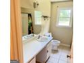 Bathroom featuring a single sink vanity, toilet, mirror, tub, shower, and window at 401 Mt. Tabor Church Rd., Dallas, GA 30157