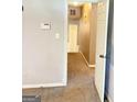 View of carpeted hallway featuring a light, a door, and a thermostat at 401 Mt. Tabor Church Rd., Dallas, GA 30157