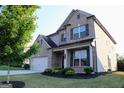 Well-maintained two-story home with a manicured lawn and mature trees at 878 W Union Grove Cir, Auburn, GA 30011