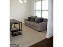 Comfortable living room with a sofa, carpet, and large window offering natural light at 878 W Union Grove Cir, Auburn, GA 30011