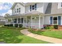 Inviting home with a charming front porch, decorative columns and neatly trimmed shrubbery at 503 Atwood Cir, Peachtree City, GA 30269