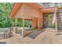 Covered carport and front porch with classic rocking chairs, enhancing the home's curb appeal at 29 Clark Pl, Whitesburg, GA 30185