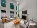 Bright living room with high ceilings, fireplace, and lots of natural light from large windows at 3832 Cherry Ridge Blvd, Decatur, GA 30034