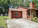 Exterior view of home with stone accent and wooden siding with ample parking space at 6698 Cameron Rd, Morrow, GA 30260