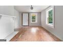Sunlit living room with fireplace, hardwood floors, and large windows at 5166 Avery Sw St, Covington, GA 30014