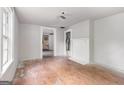 Bright living room featuring hardwood floors, neutral walls, and ample natural light at 5166 Avery Sw St, Covington, GA 30014