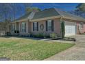 Brick home with manicured lawn, updated landscaping, garage, and dark shutters at 809 Mcbean Ct, Mcdonough, GA 30252