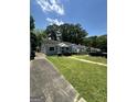 Street view of the home, showing the expansive front lawn and nearby homes at 1730 Emerald Sw Ave, Atlanta, GA 30310