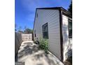 Home's side yard with a concrete path alongside the house to a fenced yard area at 1132 Se Oak Knoll Ter, Atlanta, GA 30315