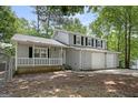 Beautiful home with gray siding, black shutters, white covered porch, and two-car garage at 2894 Cushing Ct, Jonesboro, GA 30236