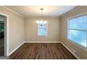 Dining area features hardwood flooring and a chandelier for warm lighting at 2159 Holly Hill Dr, Decatur, GA 30032
