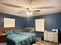 Comfortable bedroom with hardwood floors, ceiling fan, and two windows for natural light at 224 Potts Se Rd, Conyers, GA 30094