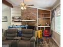 Comfortable living room showcasing a brick fireplace, built-in shelving, and stained glass window at 224 Potts Se Rd, Conyers, GA 30094