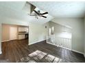 Open-concept living room with high ceiling transitions to kitchen and second-floor staircase at 5405 Lakeside Dr, Union City, GA 30291