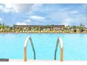 Resort-style pool area with lounge chairs under an inviting pergola, perfect for relaxation and entertainment at 1672 Fuma Leaf Way Rd, Mcdonough, GA 30253