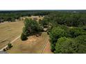 A large horse property features fenced pastures, mature trees, and a cozy home at 1024 Bethany Rd, Covington, GA 30016