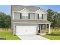 Inviting two-story home with gray siding, a spacious two-car garage, and manicured front lawn at 319 Avondale Blvd, Conyers, GA 30013