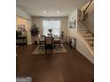 Bright dining room with a round table, hardwood floors, and natural light at 7699 Cabrini Pl, Fairburn, GA 30213