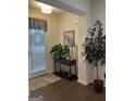 Inviting entryway with hardwood floors, console table, and decorative accents at 7699 Cabrini Pl, Fairburn, GA 30213