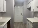 Functional kitchen with white cabinets, a back door, and vinyl flooring at 2914 Parc Lorraine, Lithonia, GA 30038