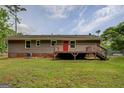Exterior view of the home with a spacious deck, perfect for outdoor entertaining and relaxation at 170 Hidden Pines Drive, Covington, GA 30016