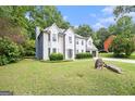 Beautiful home featuring mature trees and landscaping, a side-entry garage, and a spacious front yard at 1478 Interlaken Pass, Jonesboro, GA 30238