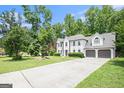 Elegant two-story home with a two-car garage, lush landscaping, and spacious driveway at 1478 Interlaken Pass, Jonesboro, GA 30238