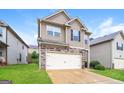 Charming two-story home featuring a stone facade and a two-car garage at 2577 Shropshire Pl, Mcdonough, GA 30253