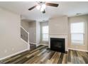 A cozy living room featuring a fireplace and hardwood floors at 2577 Shropshire Pl, Mcdonough, GA 30253