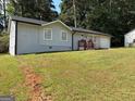 The home has a well-maintained lawn and a gray brick exterior at 3339 Clevemont Ct, Ellenwood, GA 30294