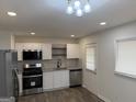 Bright kitchen with white cabinets, stainless steel appliances, and modern lighting at 3339 Clevemont Ct, Ellenwood, GA 30294