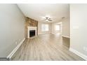 Bright living room with wood grain floors, stone fireplace, and neutral wall color at 1577 Keystone Dr, Conley, GA 30288