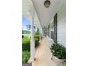 Covered front porch with white pillars and space for seating at 1226 Pine Knoll Ln, Conyers, GA 30013