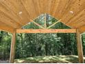 View from a carport showing the structure's wooden supports and roof with a background of trees at 518 Paynes Lake Rd, Carrollton, GA 30116