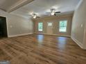 Bright living room showcases new hardwood floors, ceiling fans, fresh paint, and plenty of natural light at 518 Paynes Lake Rd, Carrollton, GA 30116
