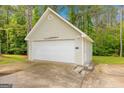 Detached garage featuring white siding, a single car door, and an airplane propeller as a decorative element at 229 Lafayette St, Locust Grove, GA 30248