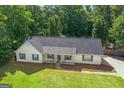 A top-down view of a charming home with a well-kept lawn, trees and a welcoming front porch at 3005 Ryan Rd, Locust Grove, GA 30248