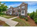 Attractive brick townhomes with green lawns, inviting walkways, and professional landscaping at 4565 Sims Park Overlook, Suwanee, GA 30024