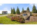 Cedar Ridge community entrance sign with stone base, flowers, and landscaping at 162 Aster Ave, Locust Grove, GA 30248
