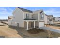 Two-story home with siding, brick accents, well-kept lawn, and a two-car garage at 162 Aster Ave, Locust Grove, GA 30248