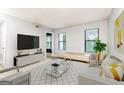Sunlit living room featuring a modern glass table, plush seating, and neutral decor at 1818 Huntingdon Chase, Atlanta, GA 30350