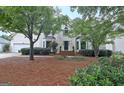 Charming two-story home featuring lush landscaping, brick accents, and an attached garage at 207 Tiverton Trl, Peachtree City, GA 30269