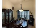 Elegant dining room featuring a large table with seating for eight, chandelier, and dark wood accents at 3505 Saddle Creek Ln, Ellenwood, GA 30294