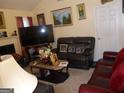 Cozy living room with a fireplace, plush seating, and tasteful decor at 4032 Ward Lake Trl, Ellenwood, GA 30294