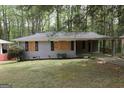 Exterior view of single-story home with gray brick and covered carport at 2364 Farley St, East Point, GA 30344