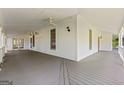 Spacious outdoor porch with grey floors and a ceiling fan at 441 Crumbley Rd, Mcdonough, GA 30252