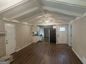 Bright and airy living room features wood floors and connects to an adjacent kitchen at 6236 Shallow Creek Ln, Douglasville, GA 30135